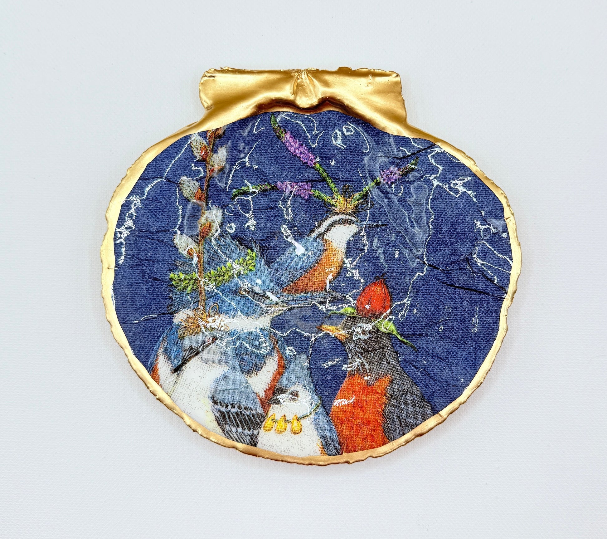 Decorative ornament with birds on a blue background on a white card.