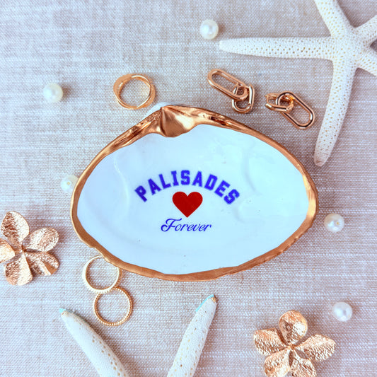 Decorative dish with 'PALISADES Forever' text on a medium clam shell with decorative elements.
