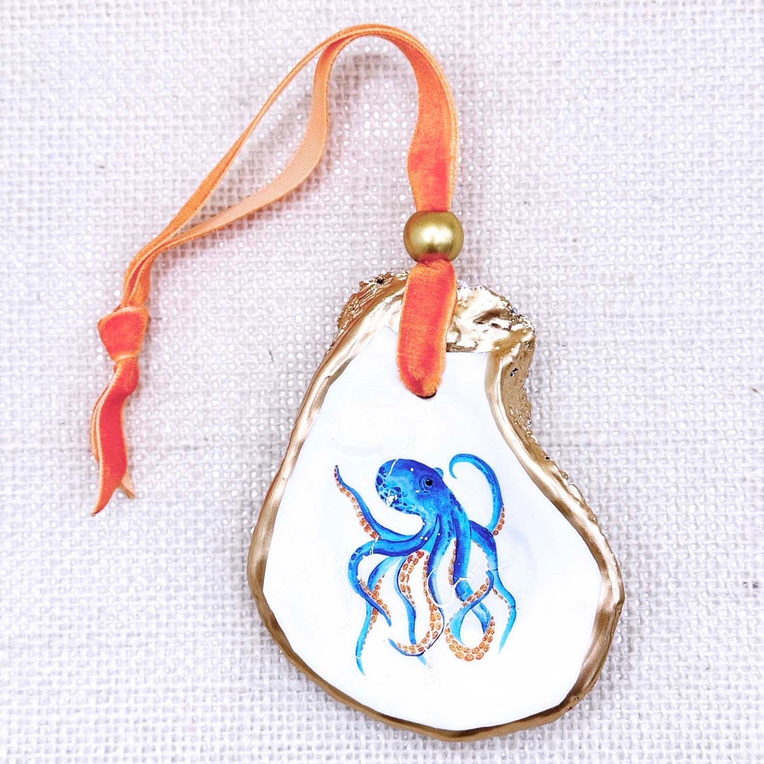Decorative ornament with blue octopus design on a white background