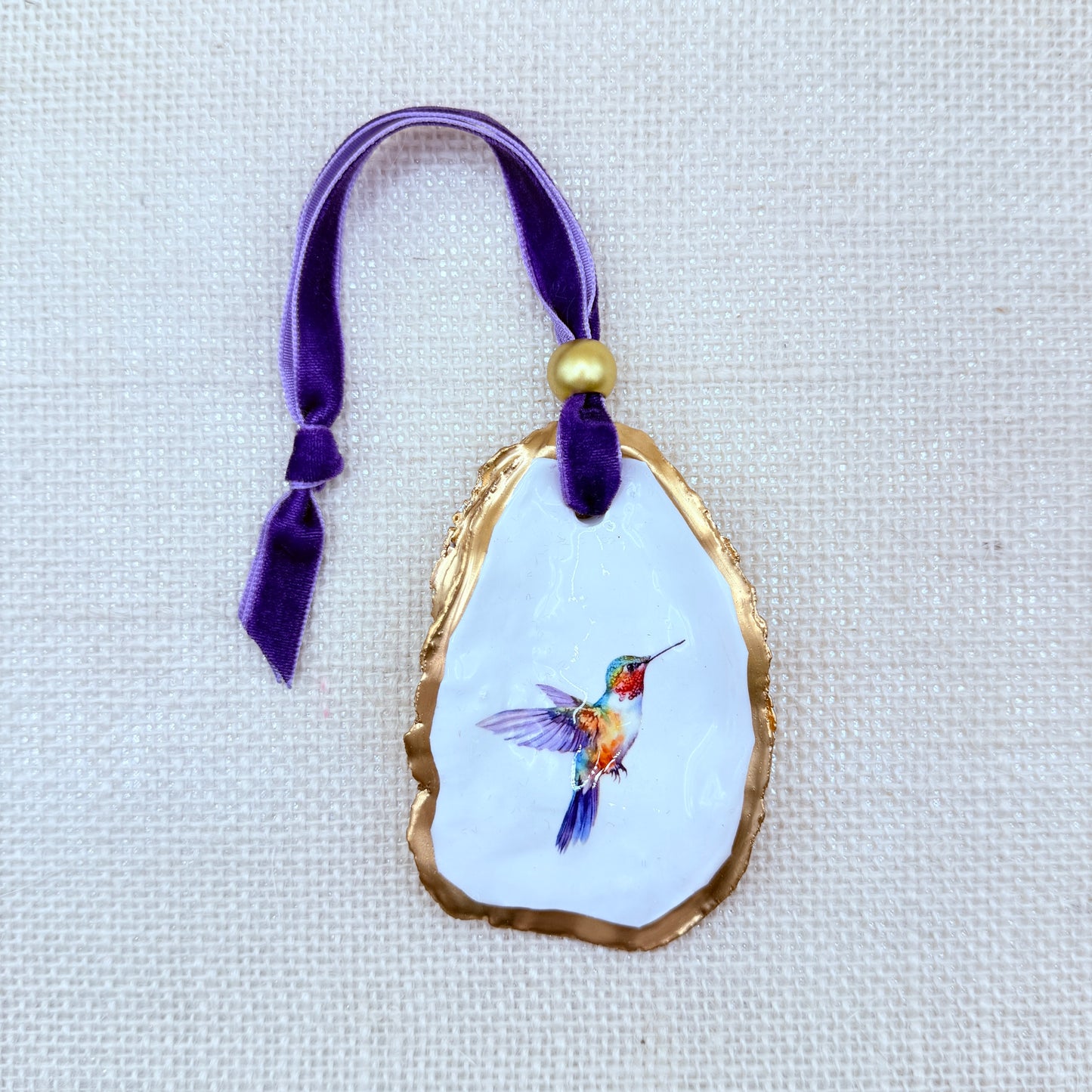 Decorative ornament with a hummingbird design on a white background
