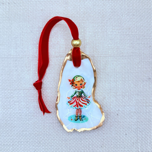 Decorative ornament with a vintage-style illustration of a elf girl in a red dress on a light background.