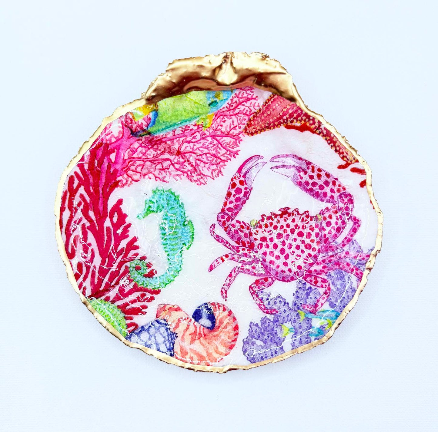 Red crab and multi colored underwater sea life design on scallop shell. 