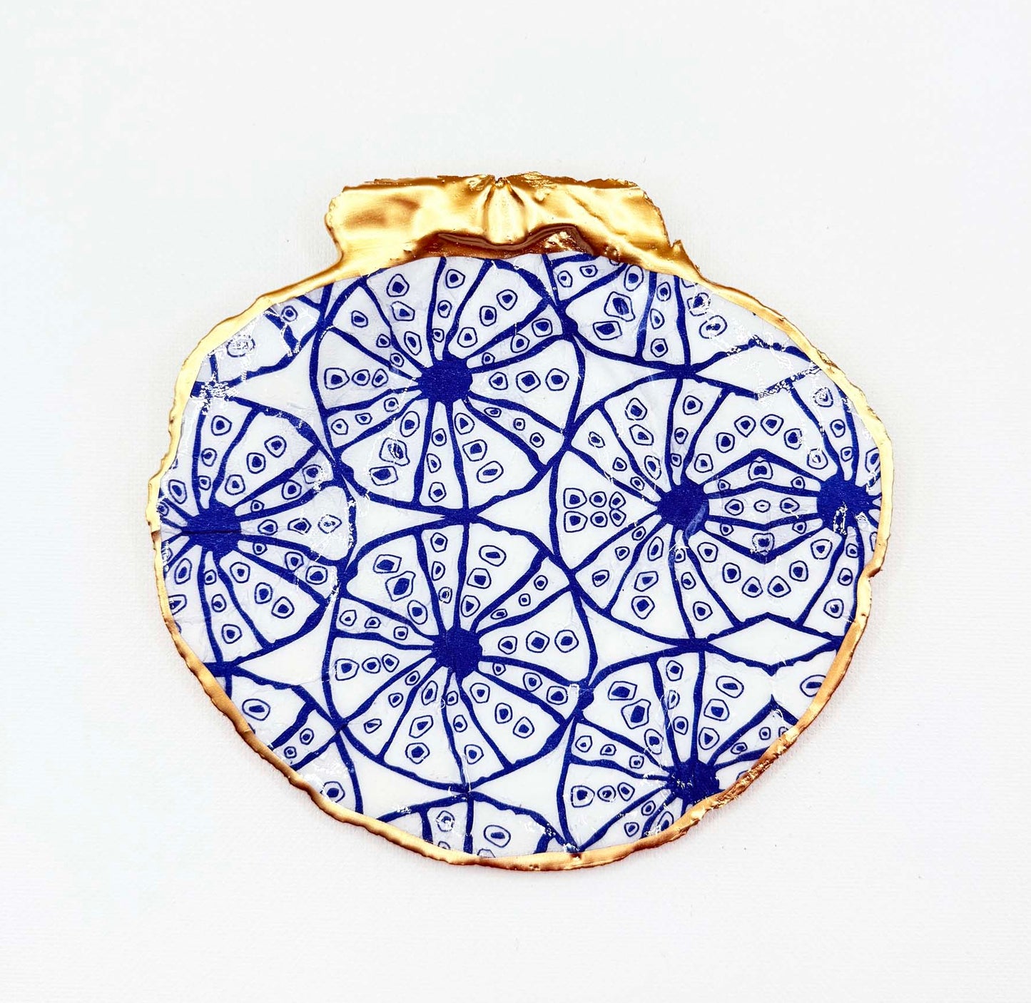 Decorative plate with blue sand dollar geometric pattern on a white background