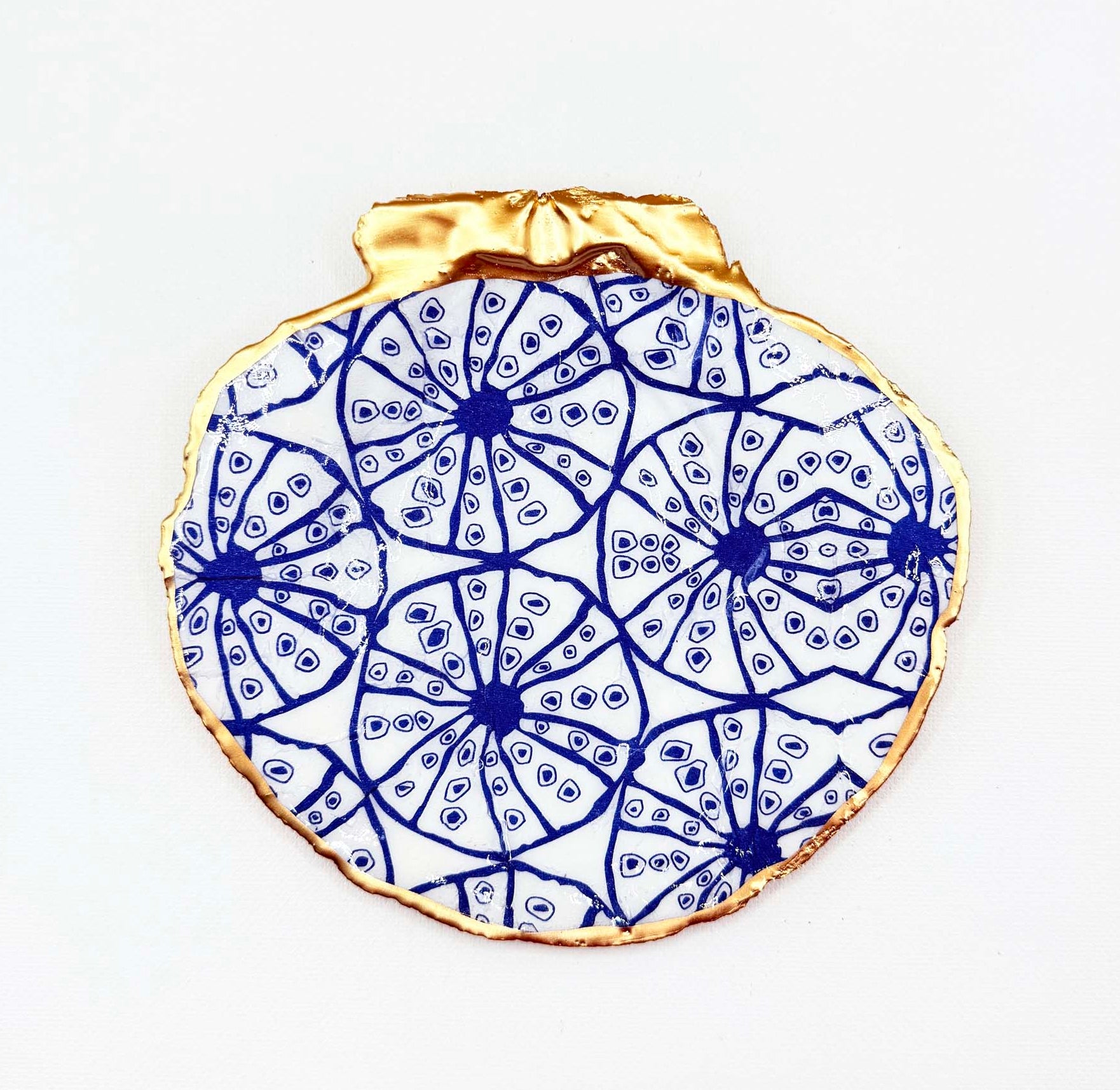 Decorative plate with blue sand dollar geometric pattern on a white background