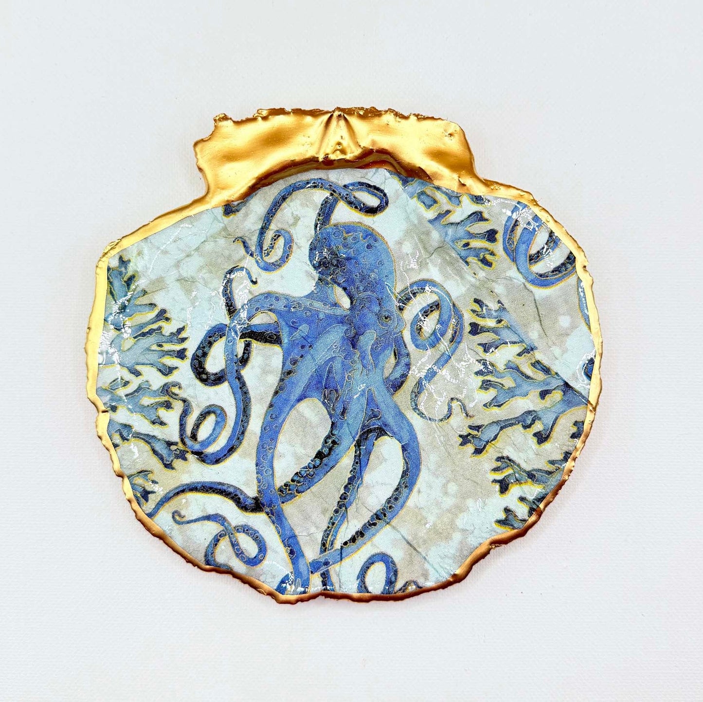 Decorative plate with blue grey octopus design set on a white background.