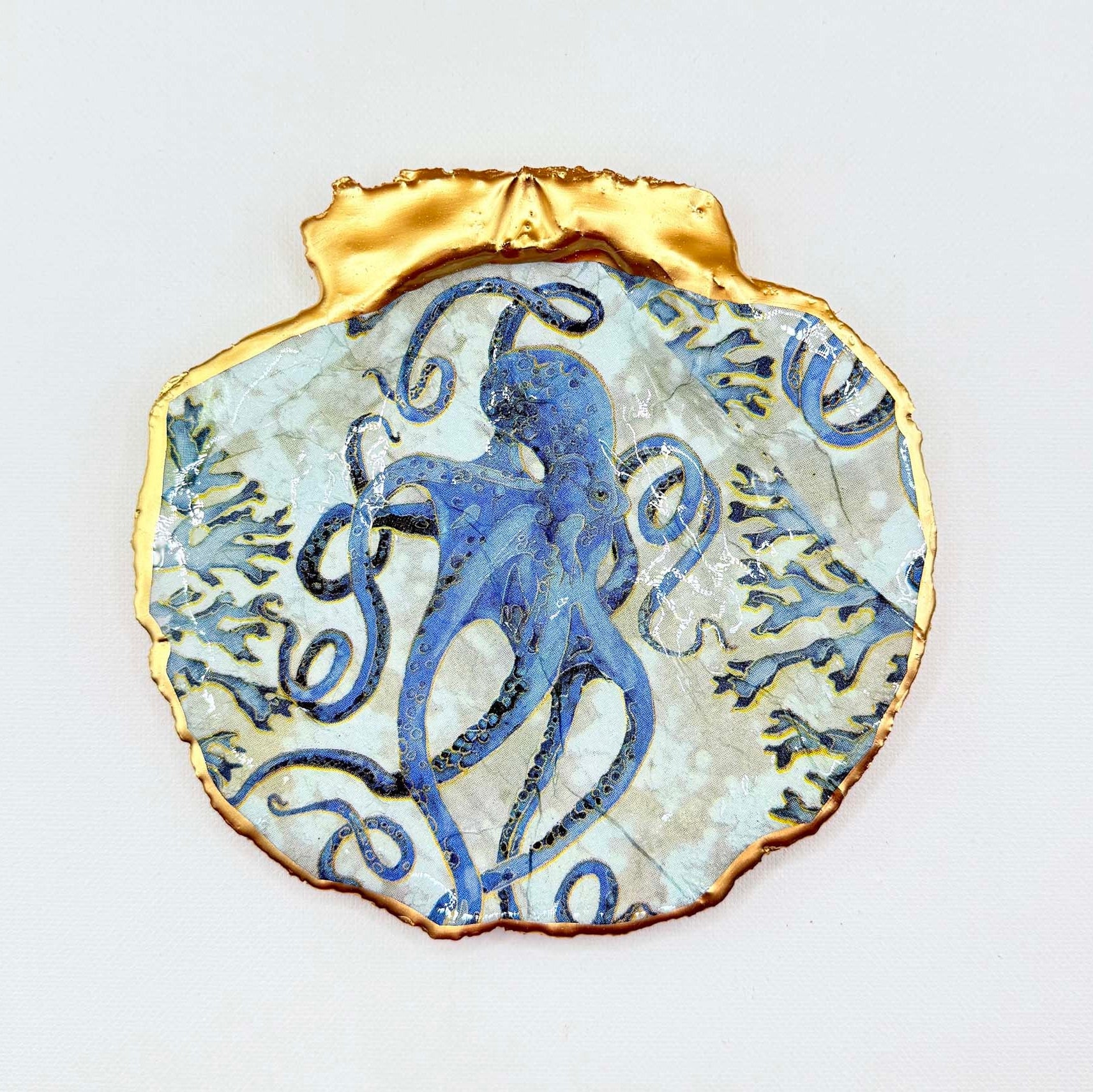 Decorative plate with blue grey octopus design set on a white background.