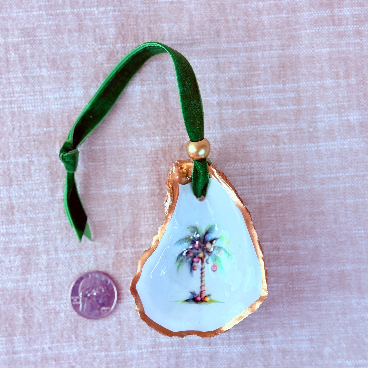 Decorative ornament with palm tree design on a beige fabric background