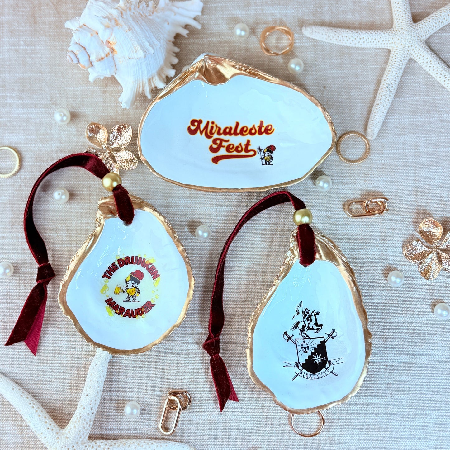 Decorative shell collection with 'Miracle Fest', Miraleste High School and characters on a textured beige surface with shells and starfish.