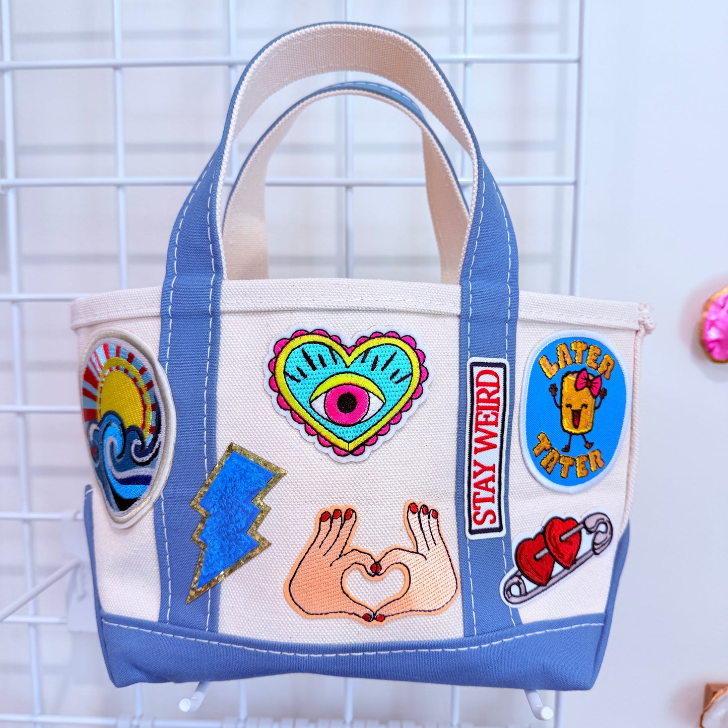Blue LL Bean Mini Boat and Tote with colorful patches on a white canvas background